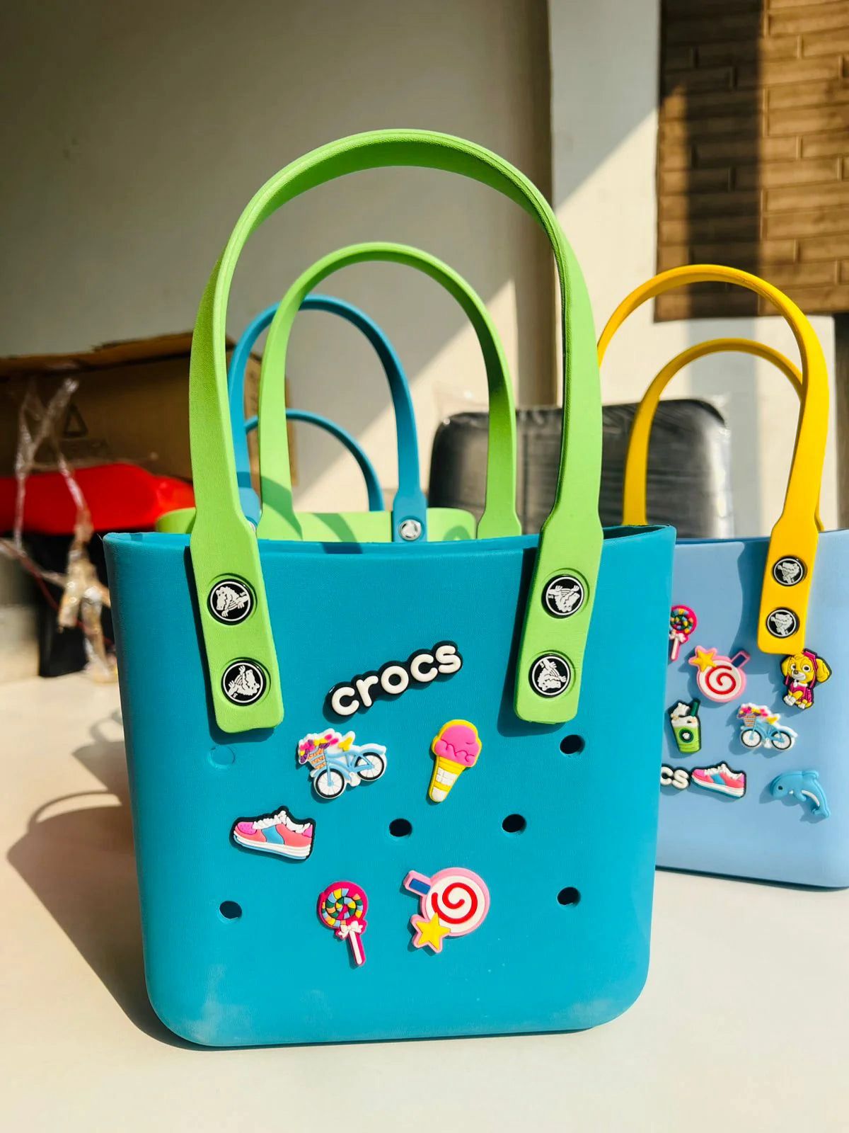 Crocs Classic Tote waterproof bags with Jibbitz charms attached